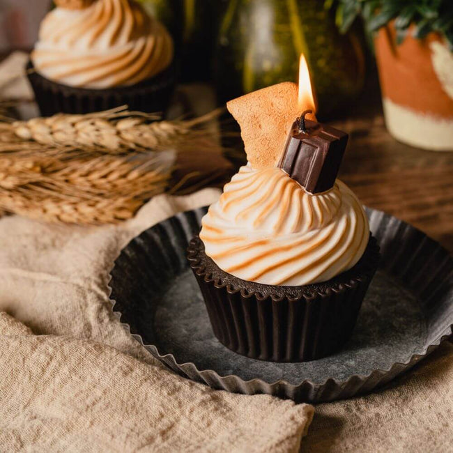 S'more Cupcake Candle - Treat yourself to the enticing scent of this delightful candle, featuring realistic graham crackers and chocolate nestled on a marshmallow cream puff. Available at Southlake Gifts Canada