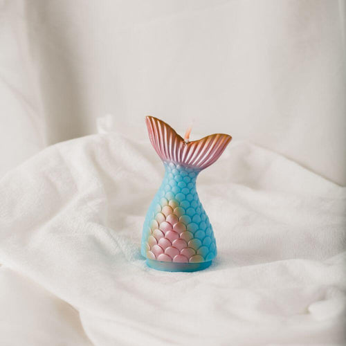 The Mermaid Tail Candle from Southlake Gifts Canada is meticulously handmade and hand-painted. Featuring effervescent scales in blue and pink tail