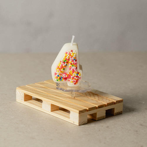 The number 4 Sprinkle Candy Number Candle from Southlake Gifts Canada to add as a cake topper for your celebration .