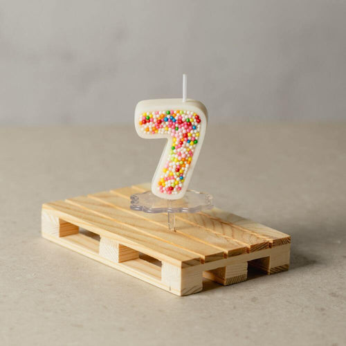 The number 7 Sprinkle Candy Number Candle from Southlake Gifts Canada to add as a cake topper for your celebration .