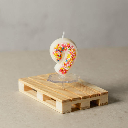 The number 9 Sprinkle Candy Number Candle from Southlake Gifts Canada to add as a cake topper for your celebration .