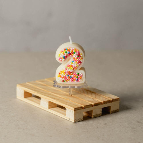 The number 2 Sprinkle Candy Number Candle from Southlake Gifts Canada to add as a cake topper for your celebration .